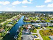 Aerial view of canal-front property and neighborhood at 15490 Mccomb Cir, Port Charlotte, FL 33981