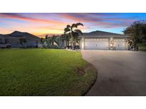 Single-Gathering home with two-car garage and lush lawn at 265 White Marsh Ln, Rotonda West, FL 33947