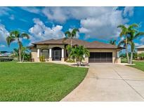 Beautiful home with a large driveway and lush landscaping at 15658 Stuart Cir, Port Charlotte, FL 33981