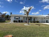 Charming front yard with manicured lawn and landscaping at 105 Crestview Dr, Englewood, FL 34223