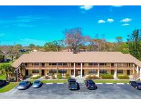 Aerial view of a condo building with parking at 23 Quails Run Blvd # 2, Englewood, FL 34223