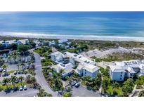 Aerial view of beachfront condos with parking and lush landscaping at 5000 Gasparilla Rd # Dc206, Boca Grande, FL 33921