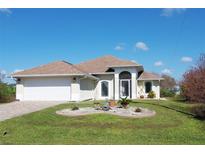 One-story home with attached garage and landscaping at 156 Crevalle Rd, Rotonda West, FL 33947