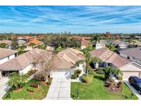 Aerial view of a single-story home with tile roof in a community setting at 3390 Osprey Ln, Port Charlotte, FL 33953