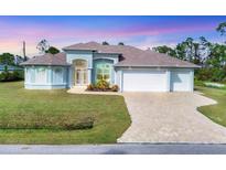 Beautiful home with a three-car garage and landscaped yard at 12194 Everglades Ave, Port Charlotte, FL 33981