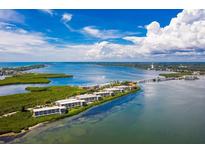 Aerial view of waterfront property with condo buildings at 1591 Beach Rd # 305, Englewood, FL 34223