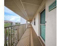 Building hallway with teal door and balcony at 175 Kings Hwy # 236, Punta Gorda, FL 33983