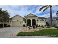 Attractive single-story home with a two-car garage and well-manicured landscaping at 24412 Lakeview Pl, Punta Gorda, FL 33980