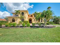 Two-story Mediterranean style home with lush landscaping at 3060 Rivershore Ln, Port Charlotte, FL 33953