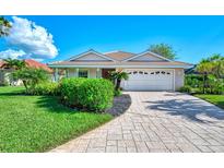 Single-Gathering home with landscaped yard and paved driveway at 3270 Bay Ridge Way, Port Charlotte, FL 33953