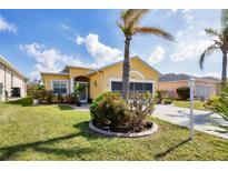 Inviting exterior with a landscaped yard and attached garage at 4261 Oak Terrace Cir, Port Charlotte, FL 33953