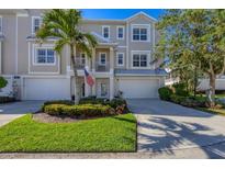 Two-story townhome with attached garage and landscaped front yard at 10325 Longshore Rd # 17, Placida, FL 33946