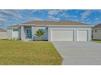 Newly built home with two-car garage and well-manicured lawn at 14304 Amestoy Ave, Port Charlotte, FL 33981