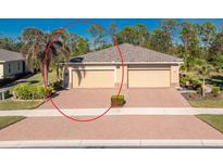 Charming single-story home with a two-car garage, paver driveway, and well-maintained landscaping at 13488 Abercrombie Dr, Englewood, FL 34223