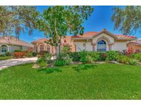 Beautiful home with lush landscaping and a tile roof at 3392 Pennyroyal Rd, Port Charlotte, FL 33953