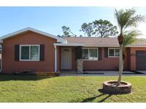 Updated single story home with a landscaped lawn and neutral color scheme at 7582 Lyncrest St, North Port, FL 34287