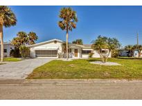 Ranch style home with carport, mature landscaping, and palm trees at 1780 Elinor Pl, Englewood, FL 34223