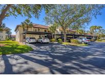 Condo complex with carport parking and lush landscaping at 520 Pine Hollow Cir # 520, Englewood, FL 34223