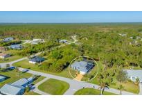 Aerial view of a single-Gathering home with a large backyard and canal at 6096 Bowie Ln, Englewood, FL 34224