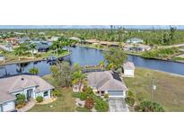 Aerial view of canal-front home with private dock and lush landscaping at 15500 Longview Rd, Port Charlotte, FL 33981