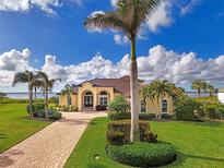 Single-Gathering home with a tile roof and palm trees, located on a waterfront lot at 3111 Rivershore Ln, Port Charlotte, FL 33953