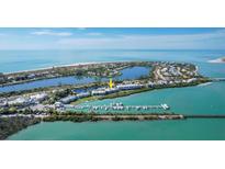Aerial view of waterfront property with boat slips and beautiful water views at 5856 Gasparilla Rd # M27, Boca Grande, FL 33921