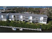 Aerial view of a waterfront condo building with private boat docks at 1401 S Mccall Rd # 306B, Englewood, FL 34223