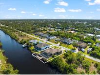 Beautiful waterfront home with private dock and screened-in lanai, perfect for enjoying the coastal lifestyle at 15104 Aldama Cir, Port Charlotte, FL 33981