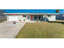 Charming mid-century home with a well-manicured lawn and a coral-colored front door at 537 Shamrock Blvd, Venice, FL 34293