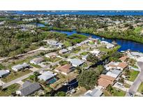 Aerial view of a waterfront home with a pool and private boat dock at 560 Sandlor Dr, Englewood, FL 34223