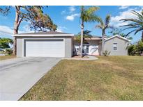 Front view of a house with a garage and palm trees at 792 Lehigh Rd, Venice, FL 34293