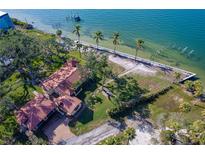 Aerial view of waterfront home with expansive lot and mature trees at 99 W Riverview Ave, Englewood, FL 34223