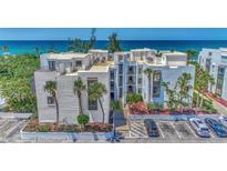 Oceanfront condo building with ample parking and lush landscaping at 2950 N Beach Rd # A315, Englewood, FL 34223