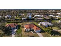 An aerial view of a Florida waterfront home with tile roof, pool, and lush landscaping at 4658 Arlington Dr, Placida, FL 33946