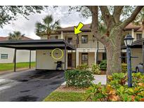 Front view of condo building with parking and landscaping at 524 Pine Hollow Cir # 524, Englewood, FL 34223