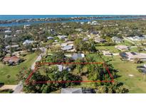 Aerial view of a single-Gathering home on a large lot, near the water at 1770 Hudson St, Englewood, FL 34223