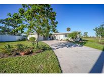 Single-story home with a landscaped yard and driveway at 22501 Bolanos Ct, Port Charlotte, FL 33952