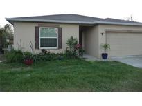 House exterior featuring a well-maintained lawn and landscaping at 22507 Provance Ave, Port Charlotte, FL 33954