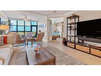 Bright living room boasts tile floors, comfortable seating, and panoramic views of the ocean at 5000 Gasparilla Rd # 73A, Boca Grande, FL 33921