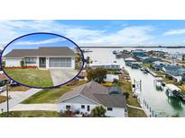 Waterfront home featuring lush lawn, canal access and beautiful water views at 1954 Arkansas Ave, Englewood, FL 34224