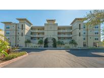 Beautiful condominium building featuring manicured landscaping and a stylish architectural design at 10045 Links Ln # 203, Rotonda West, FL 33947