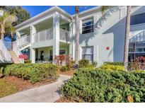 Inviting two-story condo featuring lush landscaping and a private balcony at 5725 Greenwood Ave # 8101, North Port, FL 34287