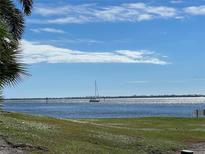 Scenic water view featuring a sailboat gliding along the calm waters on a clear, sunny day at 11000 Placida Rd # 101, Placida, FL 33946