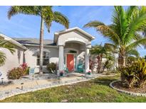 Charming home featuring a welcoming front entrance and beautifully landscaped yard at 13354 Blytheville Ave, Port Charlotte, FL 33981