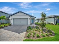 Charming single-story home with a paved driveway, manicured lawn and a 2-car garage at 6237 Fish Eagle Ct, Nokomis, FL 34275
