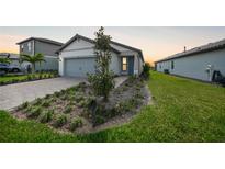 Charming single-story home featuring a two-car garage and well-maintained front yard with landscaping at 6237 Fish Eagle Ct, Nokomis, FL 34275