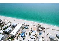 Stunning aerial view of beachfront property and crystal-clear turquoise waters with a white sandy beach at 40 Sand Dollar Ln, Englewood, FL 34223