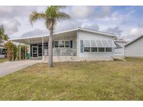 Charming single-story home with a covered carport and a cozy front porch at 8436 Buttonquail Dr, Englewood, FL 34224