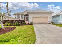 Charming single-Gathering home featuring a two-car garage, well-maintained lawn, and attractive landscaping at 16 Windward Ter, Placida, FL 33946