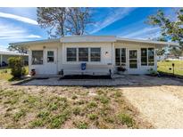Charming single-story home featuring a well-maintained front yard, bright exterior and welcoming entrance at 3220 Holly Ave, Englewood, FL 34224